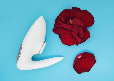 Feature photo for Paloqueth G Spot Vibrator Review. Photo shows the vibrator laying over aubergine lace lingerie.